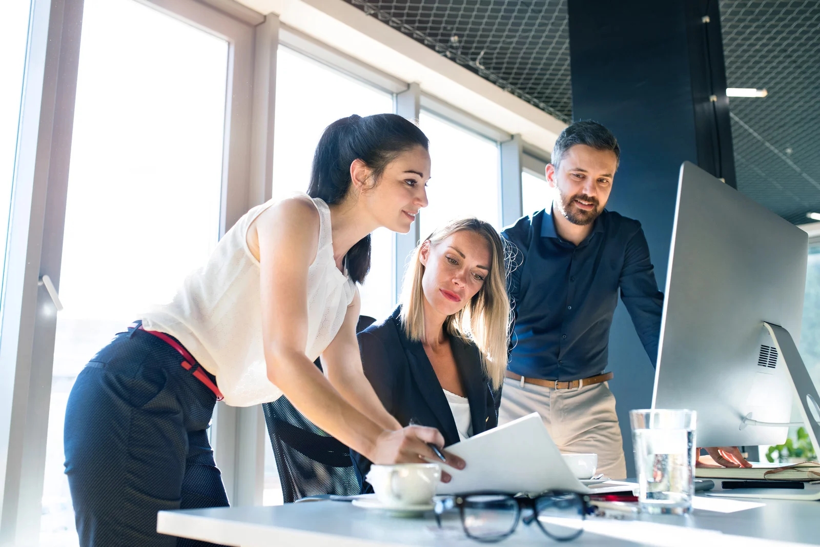 three-business-people-in-the-office-working.webp